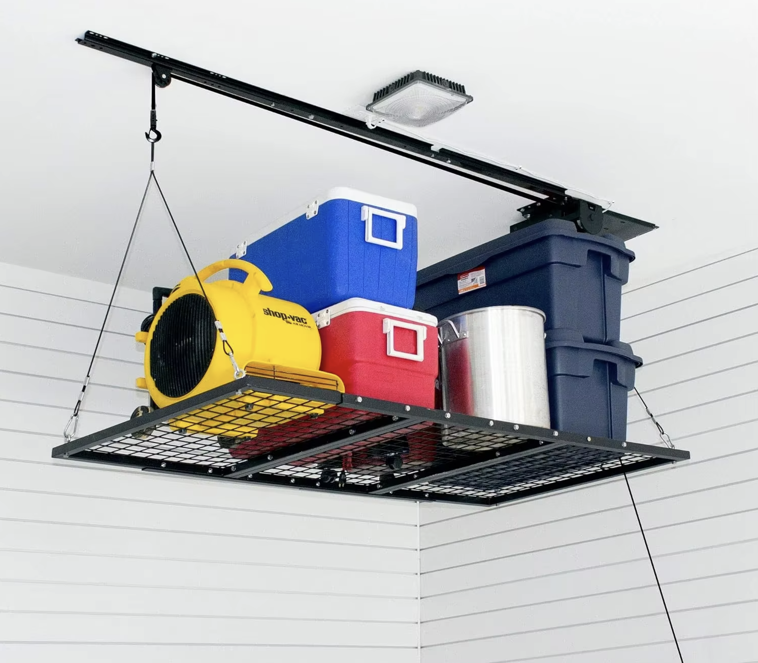 Ceiling-mounted lift carrying storage bins